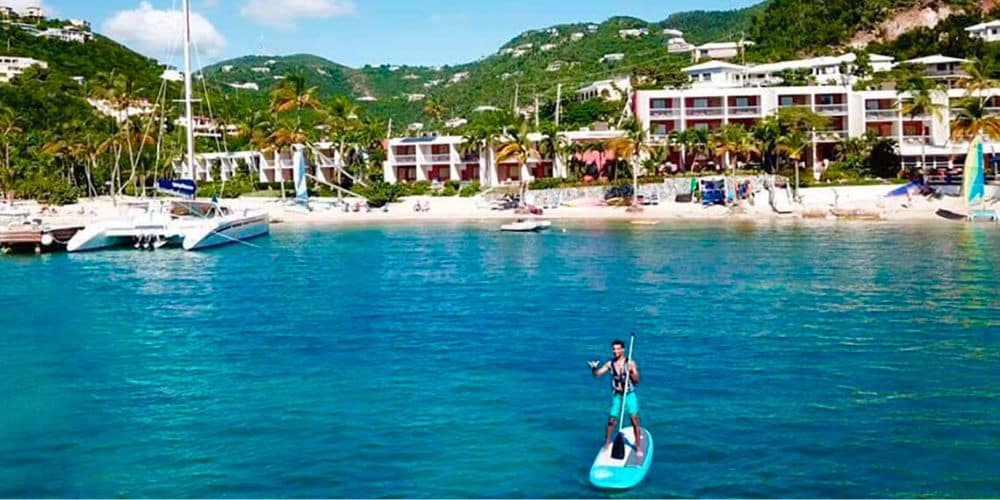 a man paddle boarding in bolongo bay.